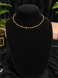 Gold-toned twist chain necklace displayed on a black velvet bust